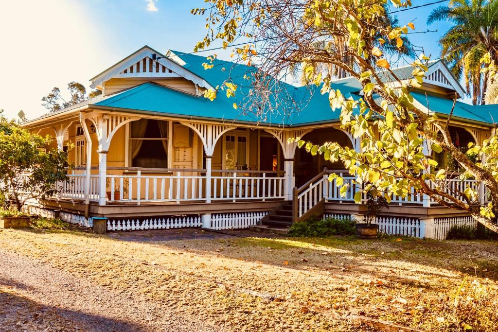 a yellow house with a blue roof at Kilkivan Homestead in Kilkivan