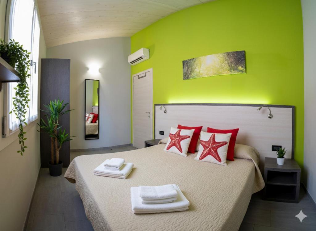 a bedroom with a large bed with red pillows at Il Sole Di Bruno in Imperia