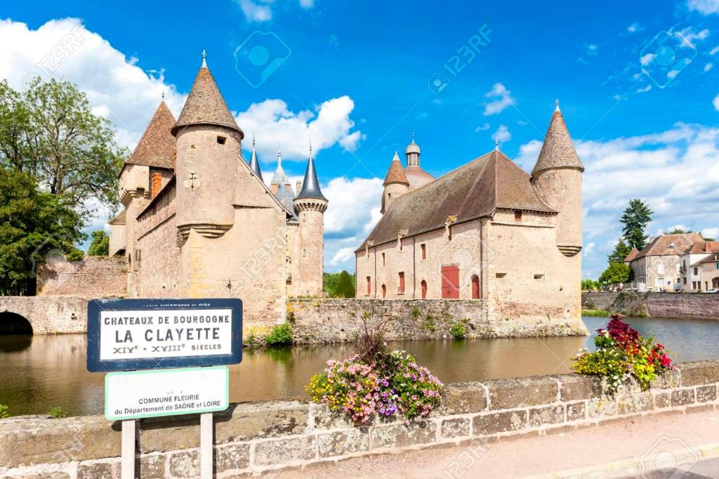 an old castle with a sign in front stock photo at Suite confortable plein cœur du village in La Clayette