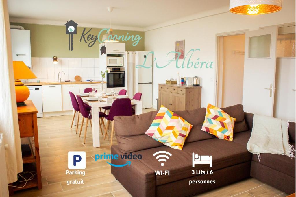 ein Wohnzimmer mit Couch und Küche in der Unterkunft L Albéra - Elégance et douceur in Albertville