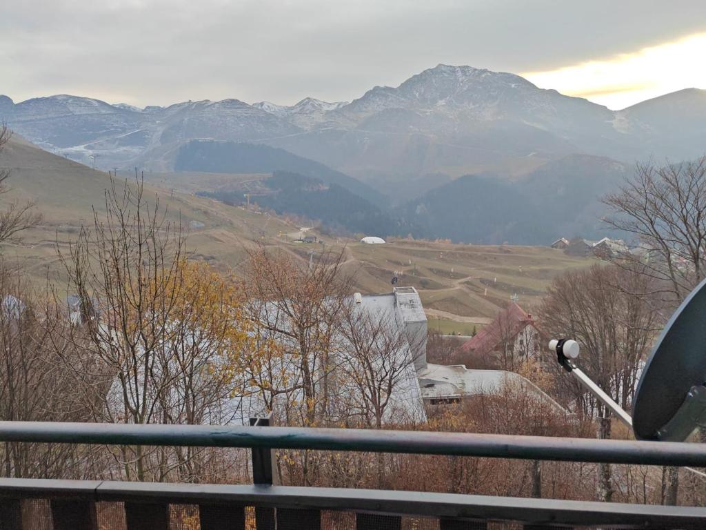 a view of a valley with mountains in the distance at La Baita del Sagittario in Prato Nevoso