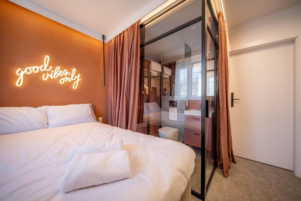 a bedroom with a bed with a sign that reads good when only at Żurawia Mini Apartments by Sofija in Warsaw