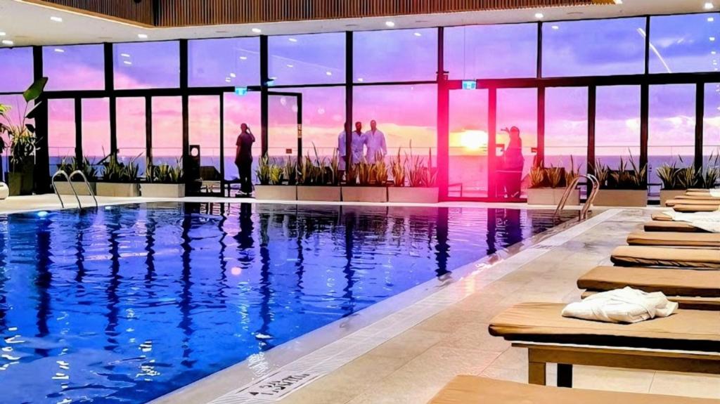 a large swimming pool with a view of the ocean at Billionare by Alliance Palace in Batumi