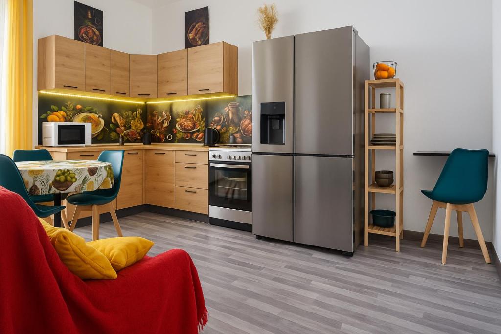 a kitchen with a refrigerator and a table and chairs at Comfortable house in Oliena