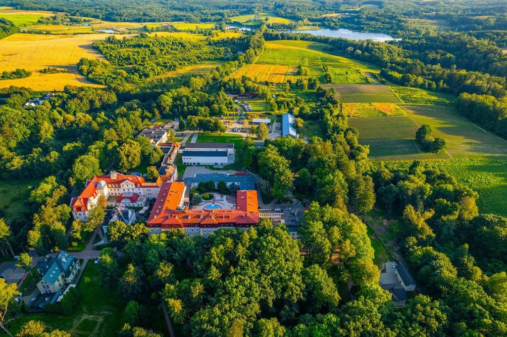 an aerial view of a building in a forest at Sanatorium Gryf in Połczyn-Zdrój