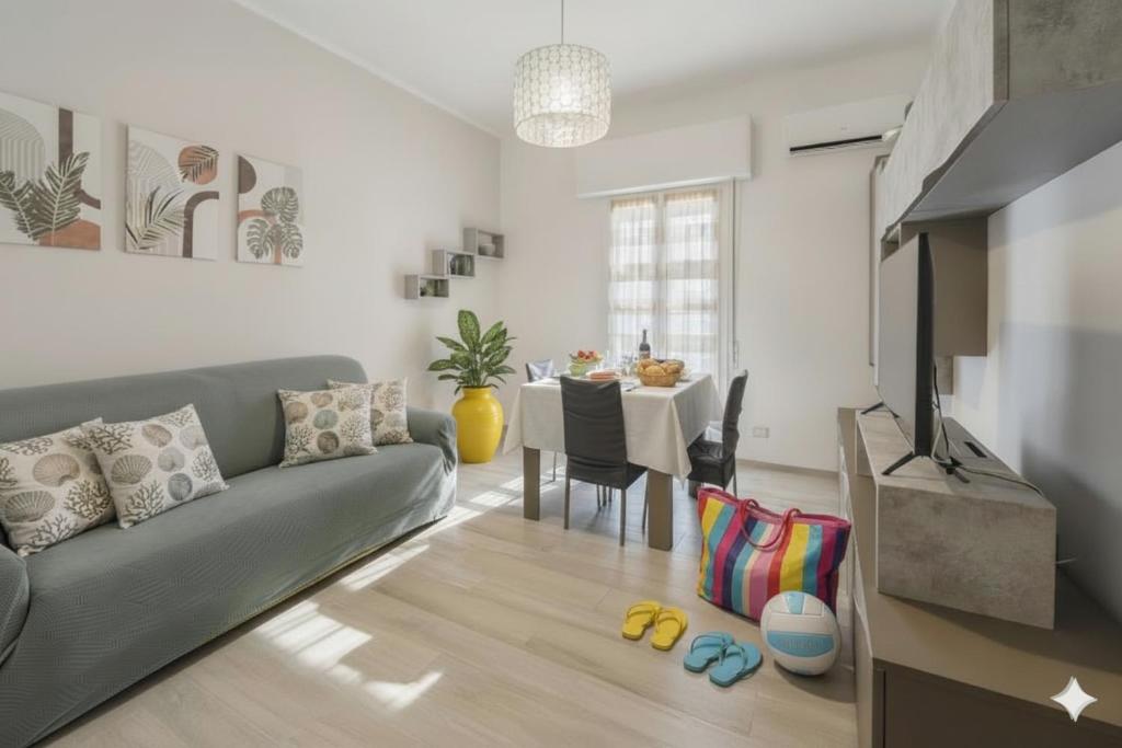 a living room with a couch and a table at Maddalena Holiday House in Imperia