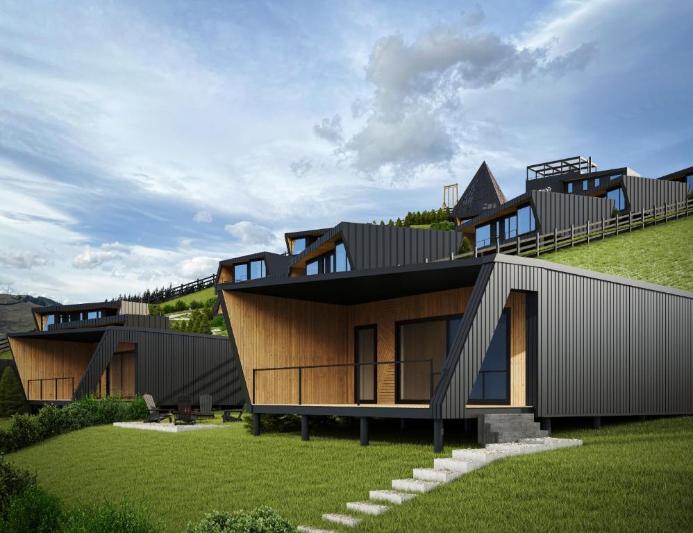 a house on top of a hill with grass at Emshir Villas in Krasnik