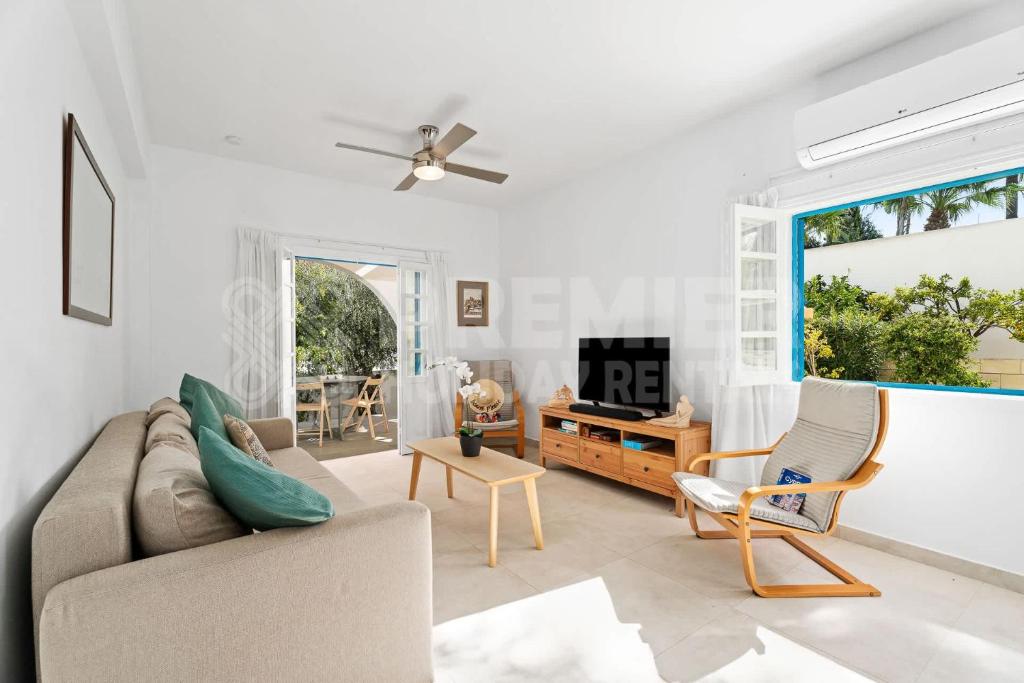 a living room with a couch and a chair at Apartment Themis in Protaras