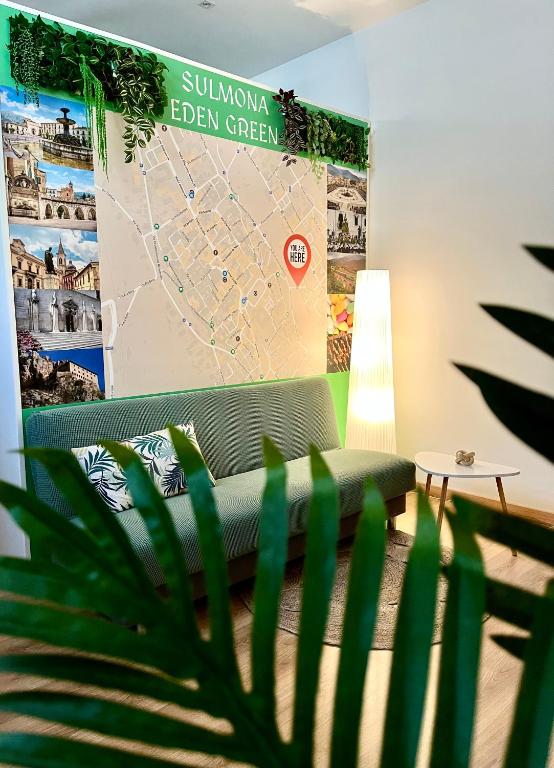 a couch in a room with a map on the wall at Appartamento Eden Green in Sulmona