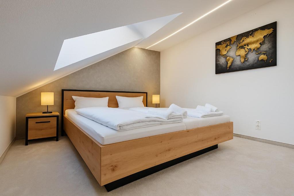 a bedroom with a large bed with a wooden frame at Moritz Apartments - Dosborn 7 in Dingelstädt