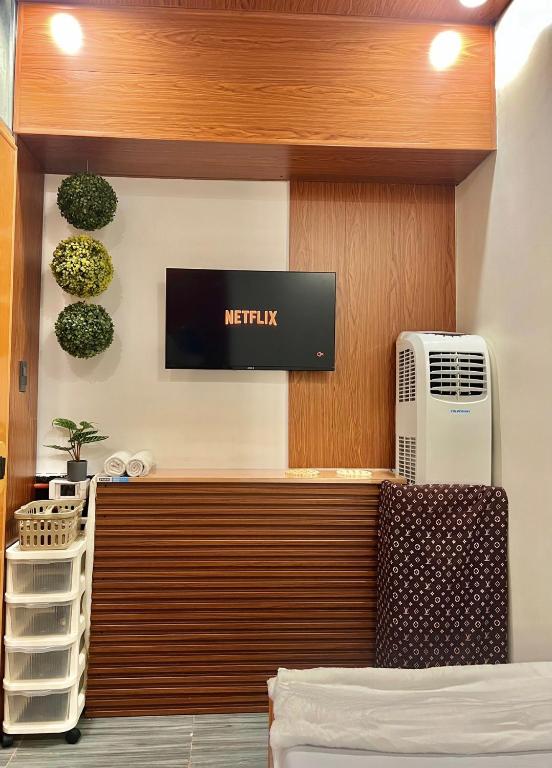 una habitación de hotel con calefacción y un televisor en la pared en Transient Room Near SM Lipa and LIMA PARK, en Inosloban