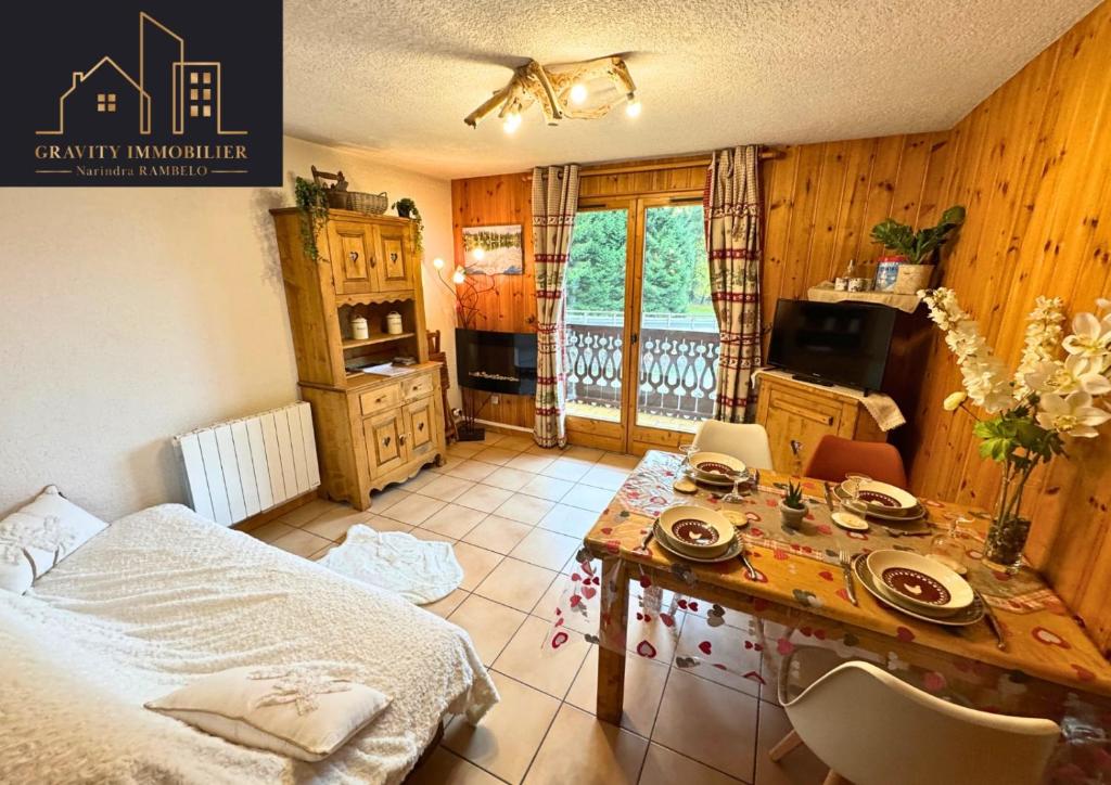 a bedroom with a table with plates and dishes on it at Chaleureux 2 chambres, Morillon in Morillon