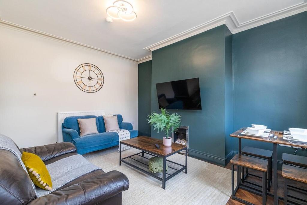 a living room with a couch and a table at Spacious Two Bed House in Headingley in Headingley