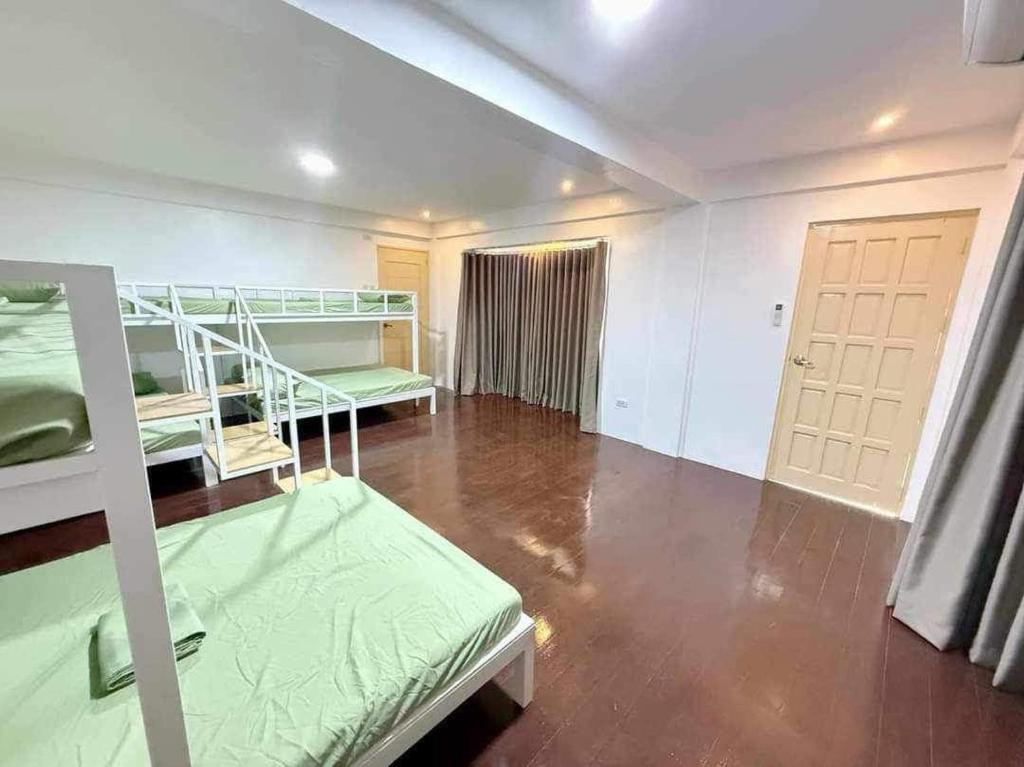 a room with two bunk beds and a hallway at Casa Sakura Family Room in Calamba