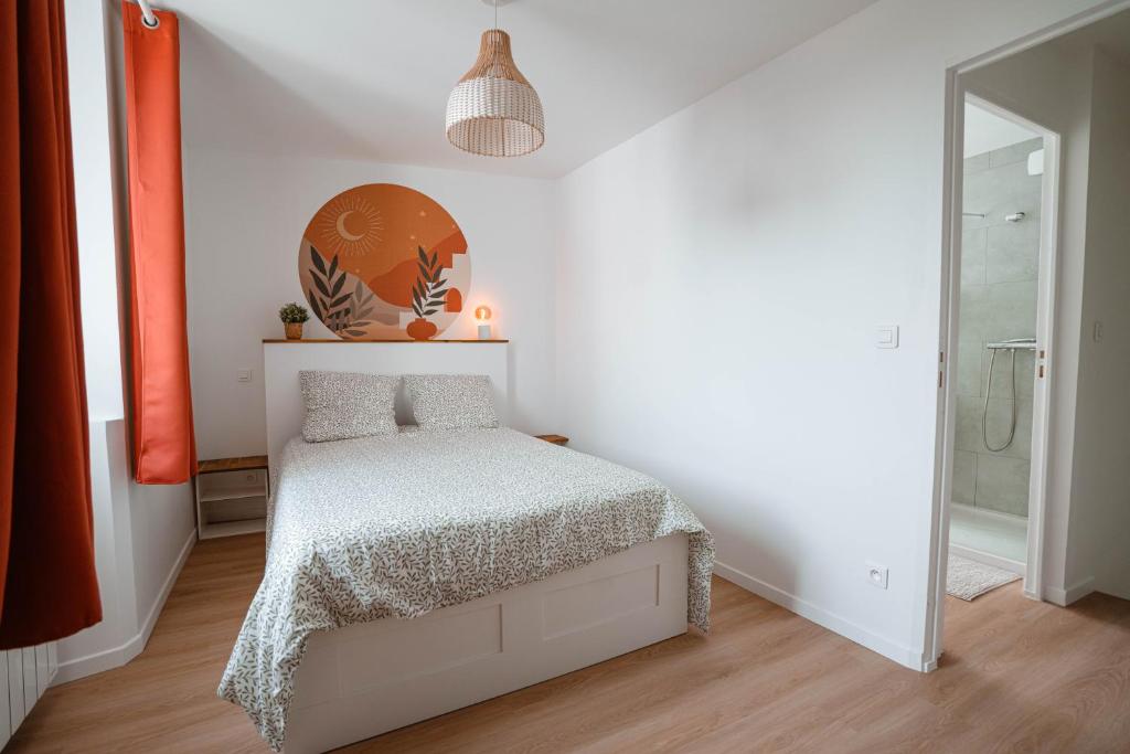 a bedroom with a bed in a white room at Charmant T2 plein centre in Saint-Astier