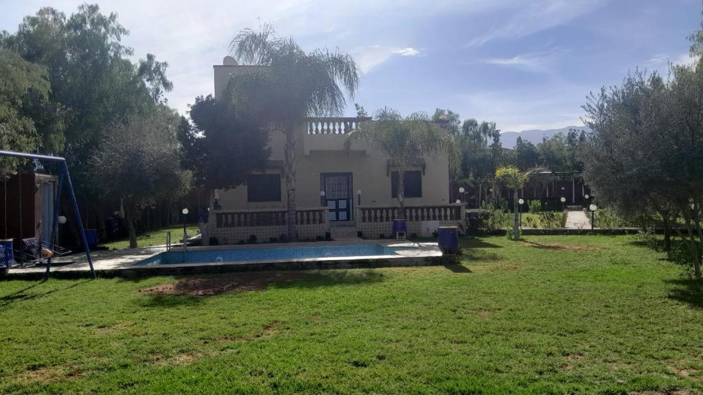 a house with a yard with a pool in front of it at Villa Tonsi in Sbiti