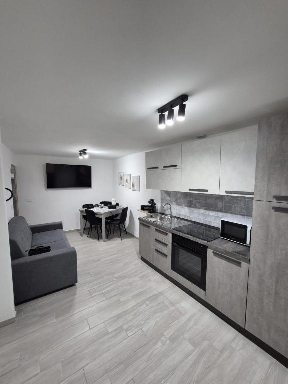 a kitchen and living room with a couch and a table at Residenza Stella in Isernia