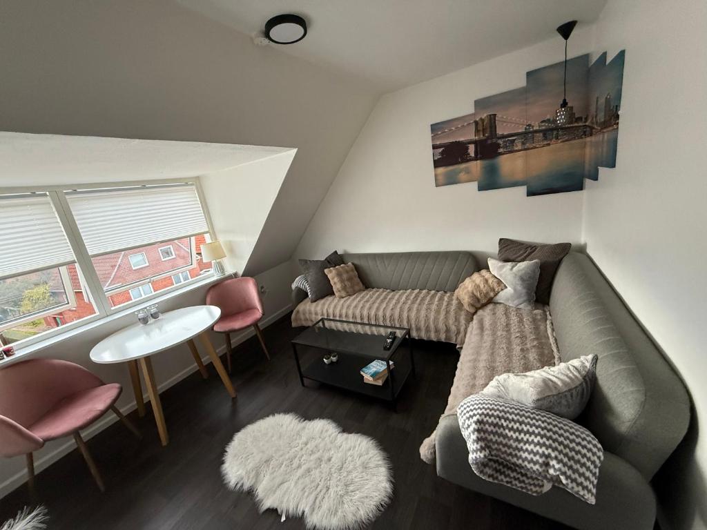 a living room with a couch and a table at Hel ændre men hyggelig lejlighed in Sønderborg