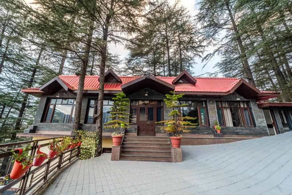 a house with a red roof and stairs to it at Treebo Premium Tranquil Inn in Shimla