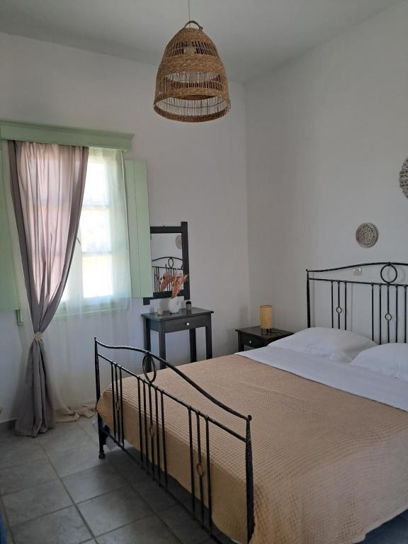 a bedroom with a large bed and a window at Marathos in Kanakis