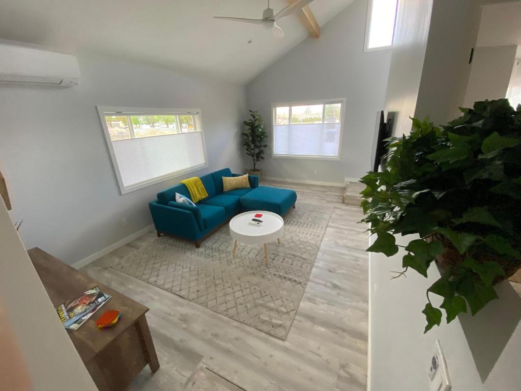 a living room with a blue couch and a table at 4th Street in Bend