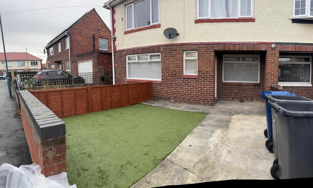 a house with a green lawn in front of it at Whitford living 1 South Shields in West Boldon