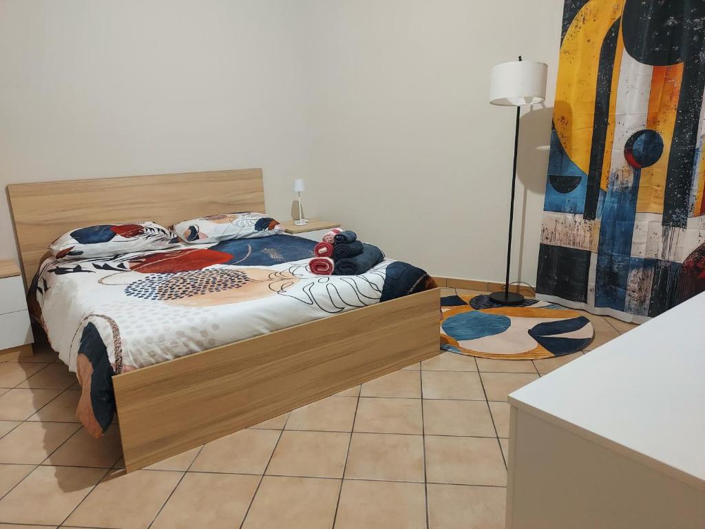 a bedroom with a bed and a tiled floor at Al vicolo dei Mori in Trecastagni