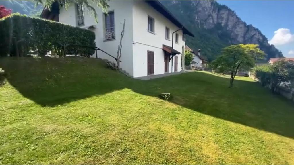 a view of a house with a green yard at Appolo in Vouvry