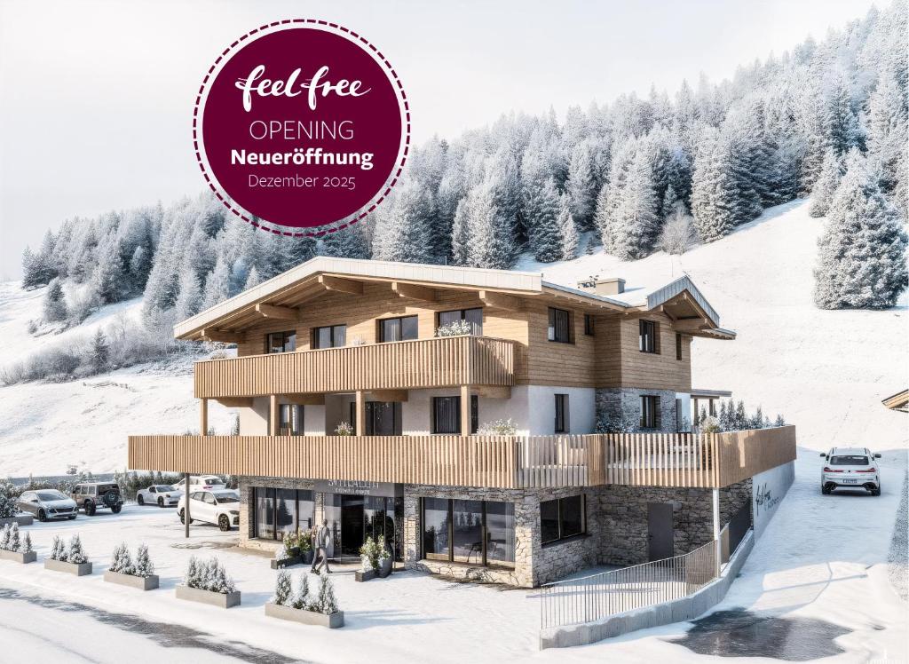 Un bâtiment sous la neige avec une pancarte indiquant « Fabrication de descendants d'arbres feutrés » dans l'établissement Feelfree Apartments Ochsengarten, à Oetz