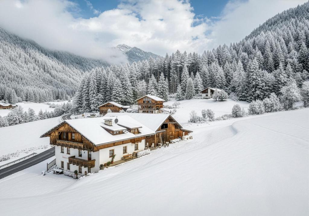a house covered in snow in a mountain at Wieserhof Vals in Valles