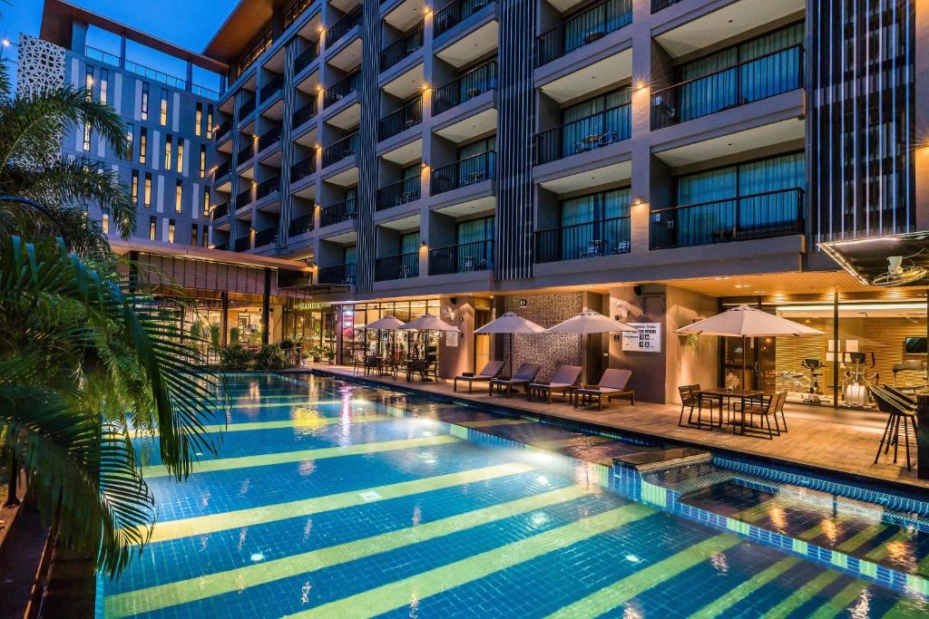 a swimming pool in front of a building at Siamese Hotel Pattaya, BW Signature Collection in North Pattaya