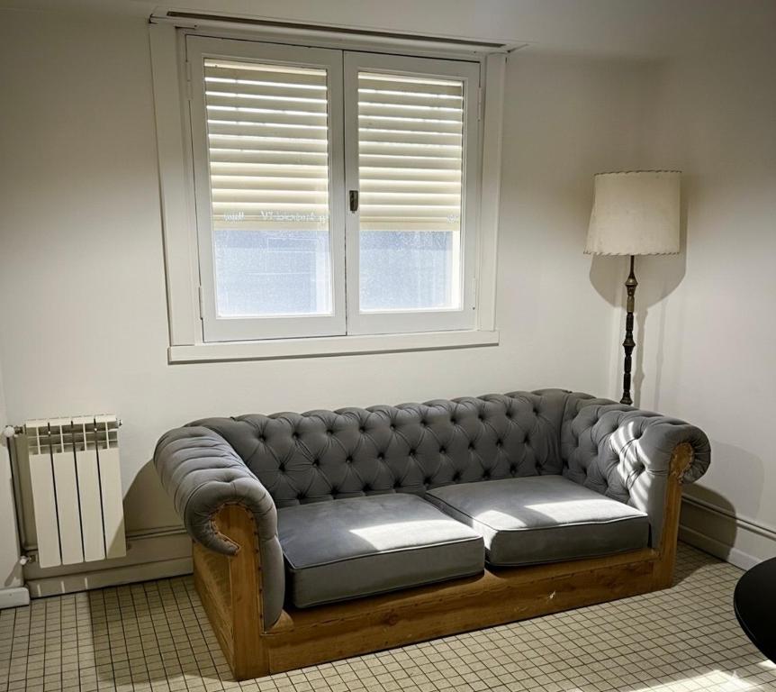 a couch in a living room with a window at Dpto SAN MARTIN in Azul