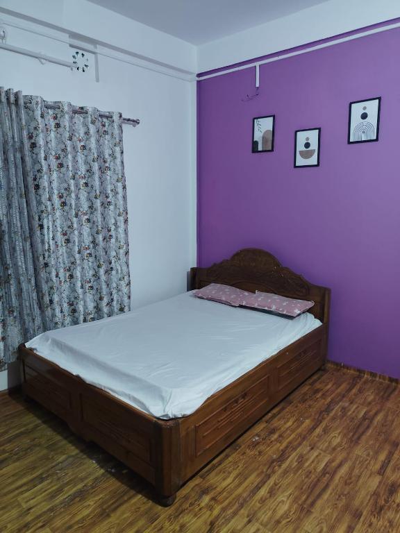 Ένα ή περισσότερα κρεβάτια σε δωμάτιο στο Rumba Homestay