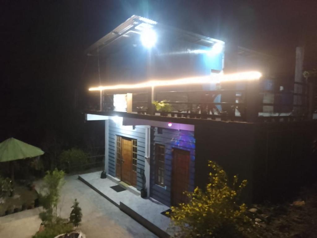 a night view of a house with lights on it at Rumba Homestay in Darjeeling
