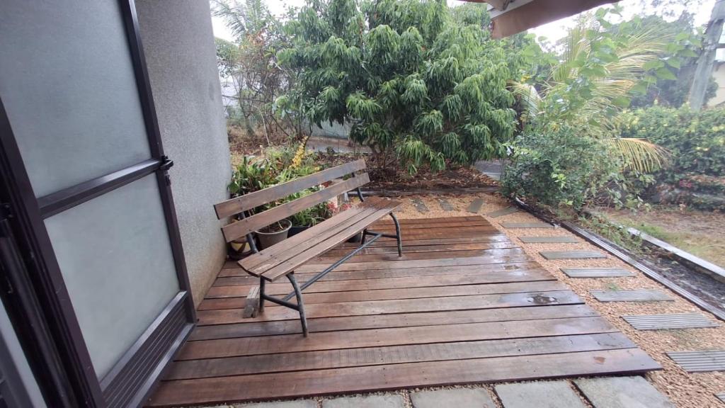 a bench sitting on a wooden deck next to a building at Ti kaz Amater Cascavelle in Cascavelle