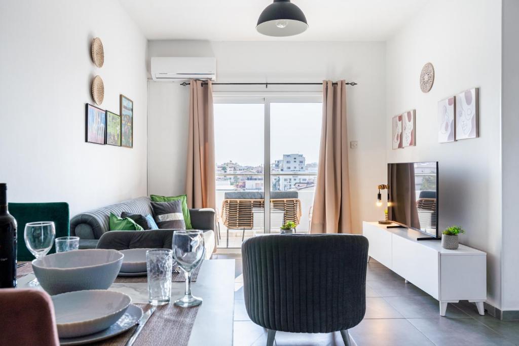 a living room with a table and chairs at Sonic 2-Bedroom Apartment in Larnaca