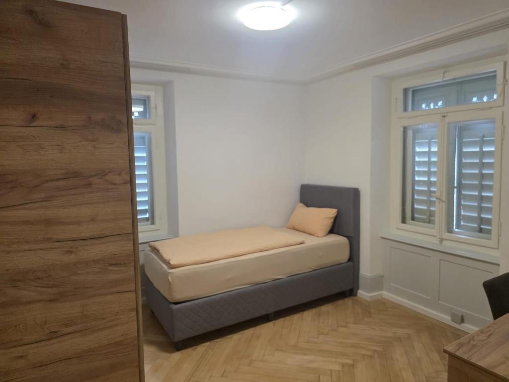 a small room with a bed and a window at Erholung am Vierwaldstättersee, komfortables 3-Bett-Zimmer in Brunnen in Brunnen