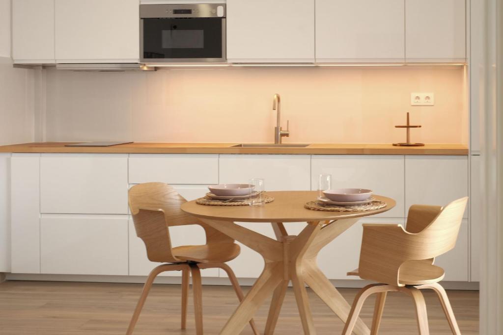 a kitchen with a wooden table and two chairs at Finca el Moral by Huskalia in Los Llanos de Aridane