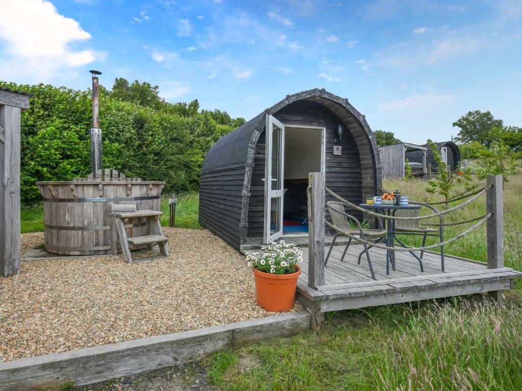 a black dome tent with a table and a barrel at The Sheep Pod - Uk50074 in Welshpool