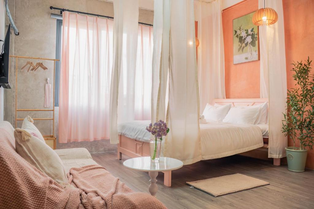 una camera da letto con un letto, un divano e un tavolo di M Maison- Stay chill in District 1 ad Ho Chi Minh