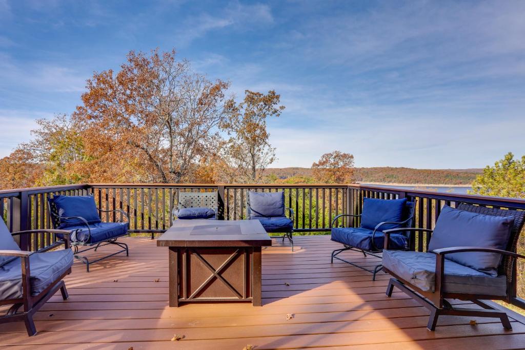 a deck with chairs and a table on a deck at Spacious Norfork Lake Home Game Room and Views! in Elizabeth