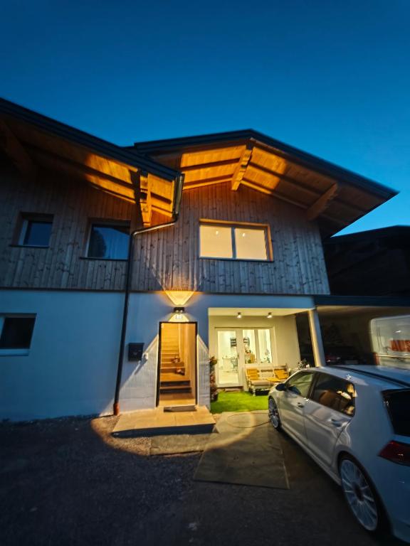 a house with a car parked in front of it at HausTipTop in Flachau