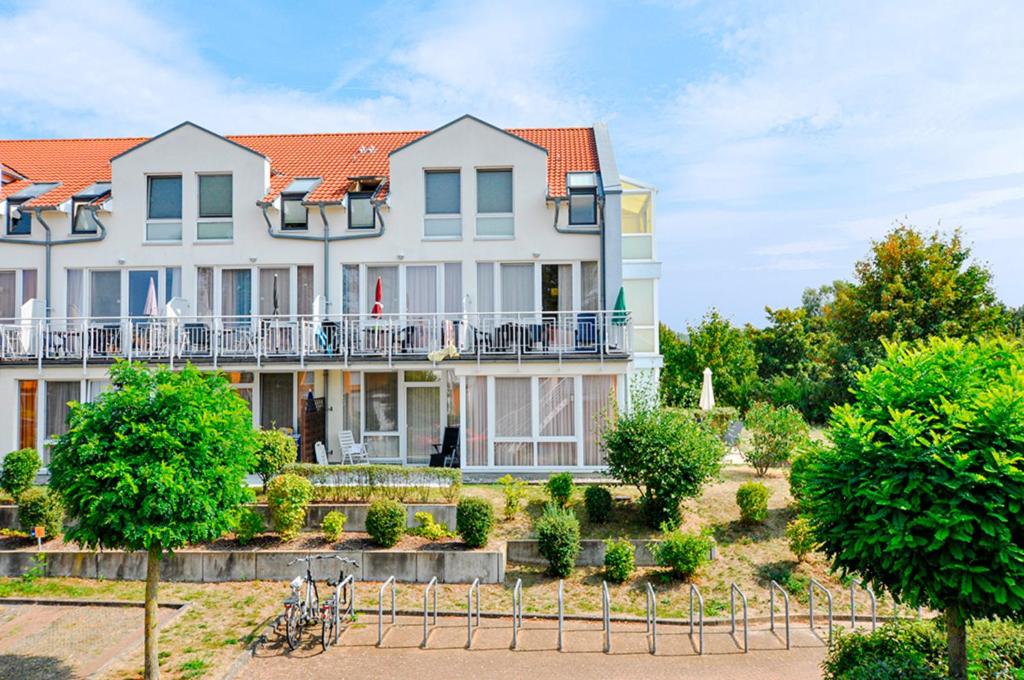 a large white house with an orange roof at Residenz Meeresblick D Fewo E5 in Rerik