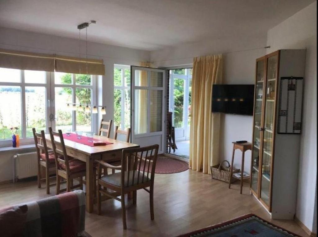 a living room with a dining room table and chairs at Mühlenblick in Dänschendorf