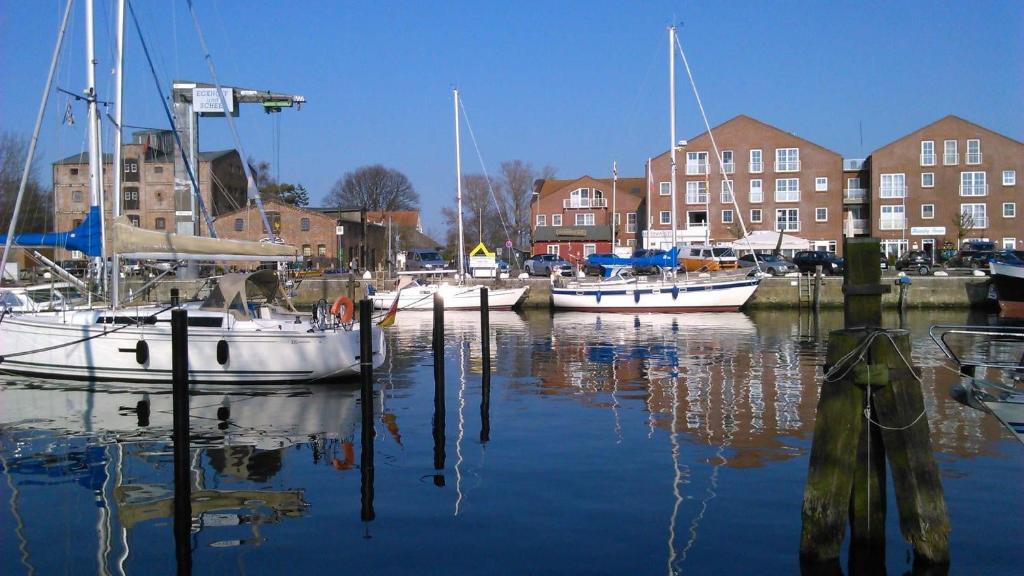 a group of boats are docked in a harbor at Hafenblick in Orth