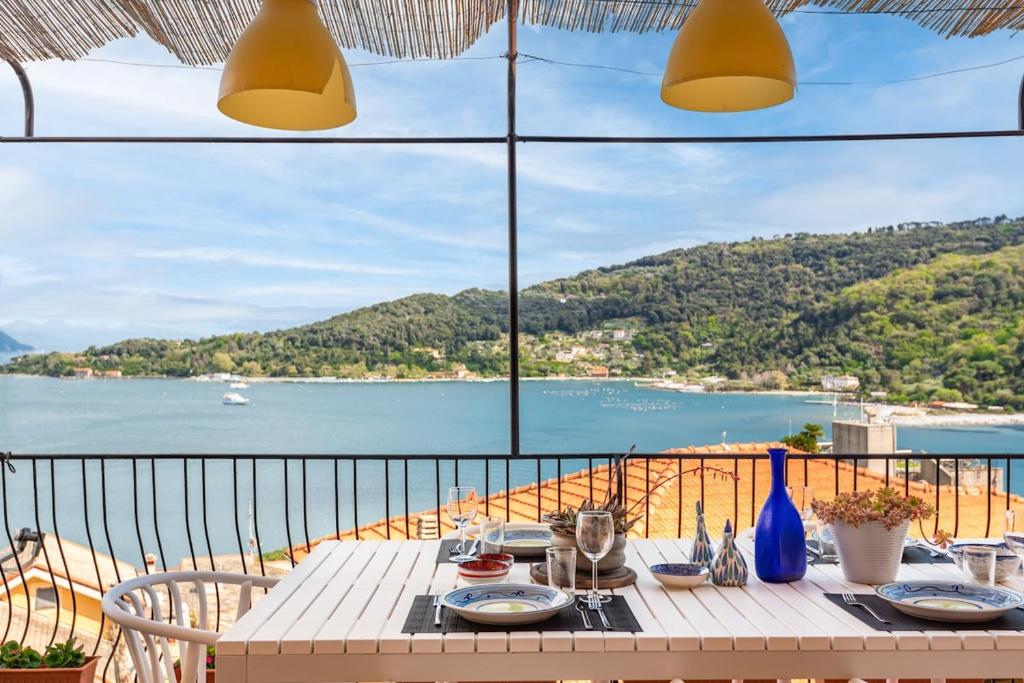 a table on a balcony with a view of the water at Porto sea view-Terrace & AC in Portovenere