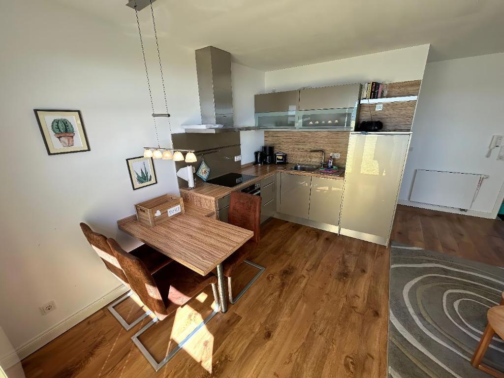 a kitchen and dining room with a wooden table at Schöne Aussicht in Orth