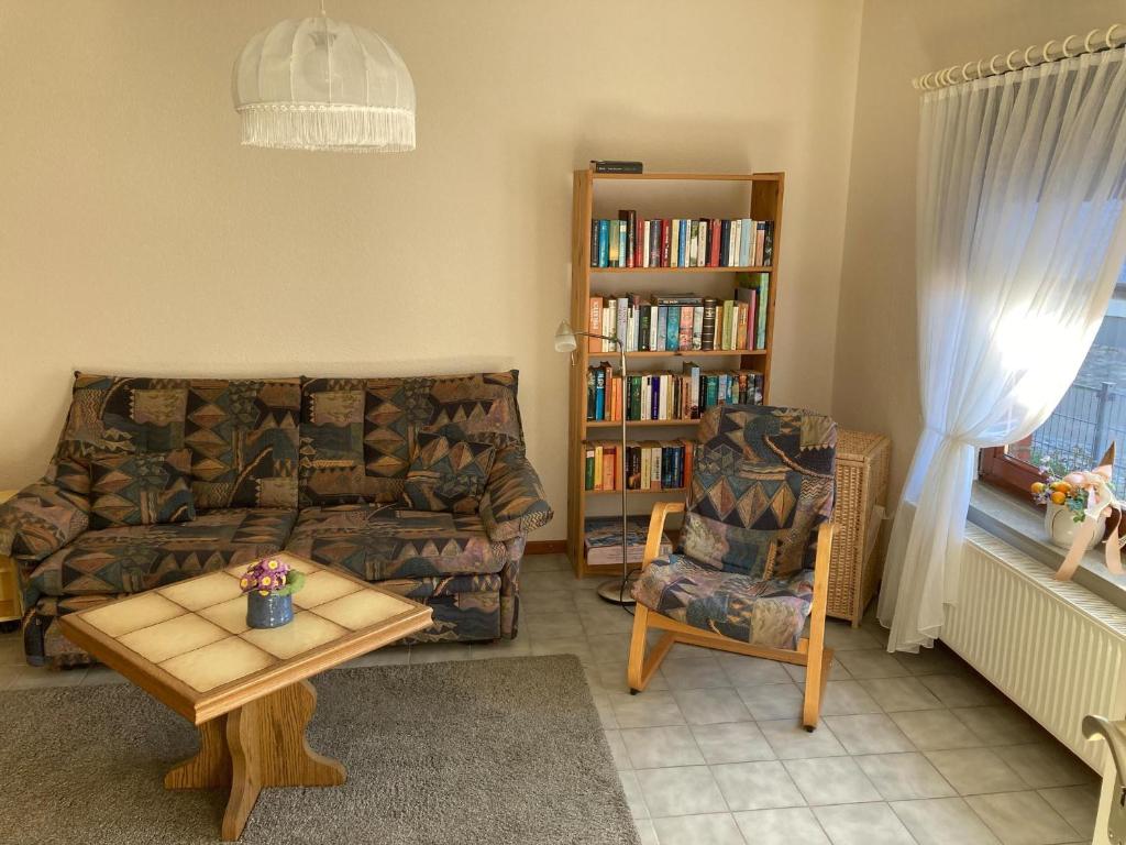 a living room with a couch and a book shelf at Orth Poststraße 8 EG in Orth