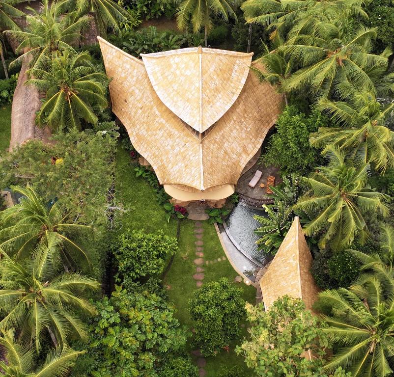 an overhead view of a garden with an umbrella at Cacao House Eco-Luxury Family Home by IBUKU near Green School Bali in Bringkit
