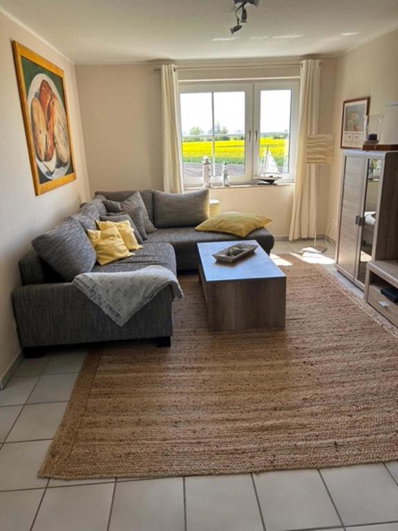 a living room with a couch and a coffee table at Wohnung mit Balkon und Aussicht in Petersdorf auf Fehmarn